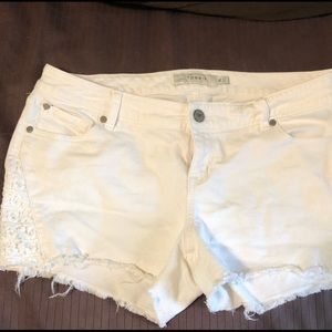 White cutoff shorts with lace detail